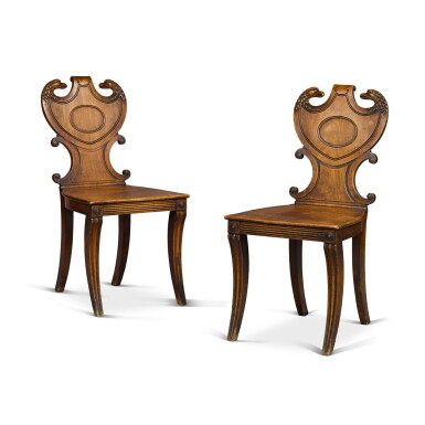 View full screen - View 1 of Lot 82. A pair of Regency carved mahogany hall chairs, first quarter 19th century.
