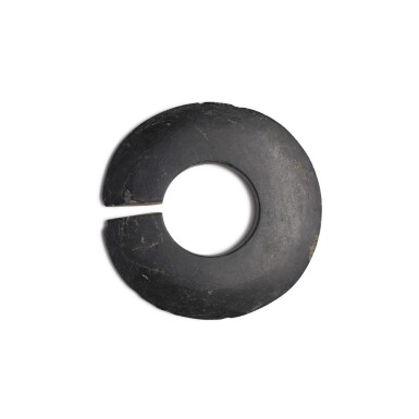 View full screen - View 1 of Lot 226. A black stone slit disc (Jue), Neolithic period / Shang dynasty | 新石器時代 / 商 石玦.