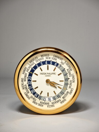 View full screen - View 1 of Lot 111. PATEK PHILIPPE/INDUCTA | A LARGE GILT BRASS WALL CLOCK WITH WORLD TIME DIAL, CIRCA 2000.