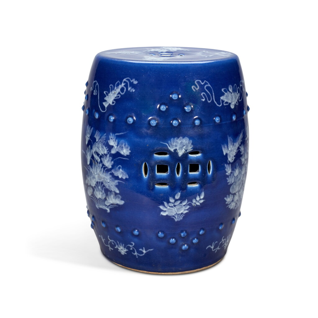 View full screen - View 1 of Lot 67. A slip-decorated blue ground barrel-form stool, 19th / 20th century | 十九 / 二十世紀 藍地堆白花卉紋坐墩.