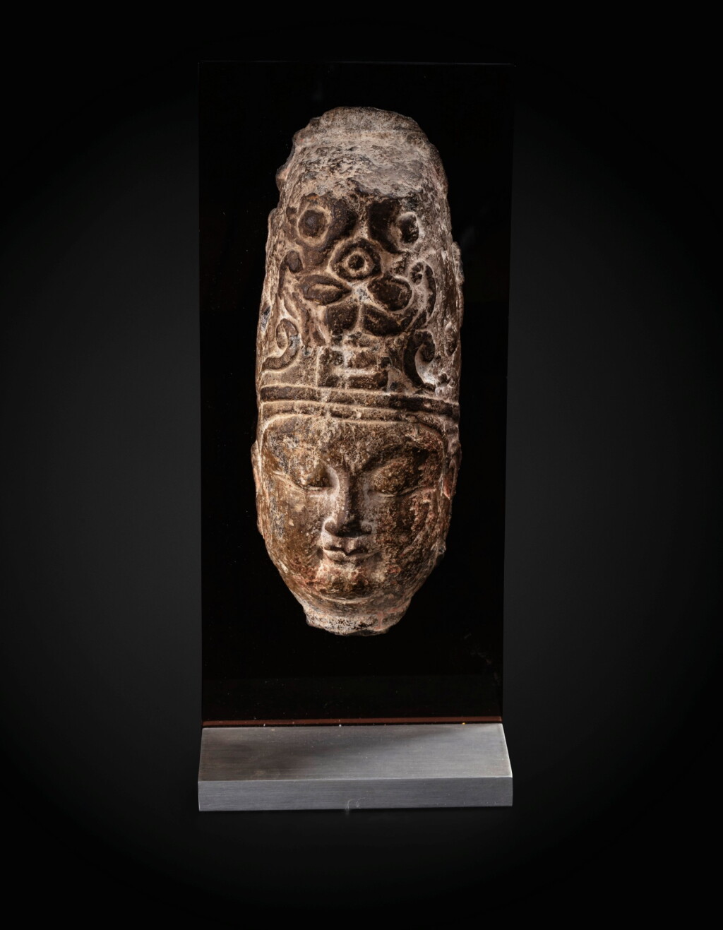 View full screen - View 1 of Lot 23. An important fragmentary relief head of an attendant Sui dynasty-Tang dynasty, ca. 7th century | 隋至唐 約七世紀 石浮雕神首殘件.