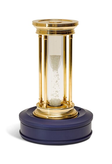 View full screen - View 1 of Lot 213. DE BEERS | A LIMITED EDIITON GOLD-PLATED HOURGLASS WITH FLOATING DIAMONDS, CIRCA 2000.