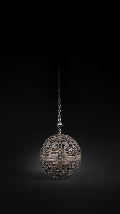 View full screen - View 1 of Lot 214. A rare silver reticulated spherical censer, Tang dynasty | 唐 銀鏤空纏枝葡萄紋香球.