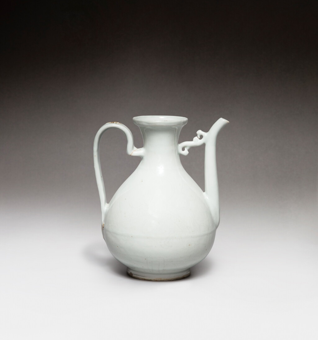 View full screen - View 1 of Lot 43. A white-glazed incised 'dragon' ewer, Ming dynasty, 16th century | 明十六世紀 白釉暗刻龍紋執壺.