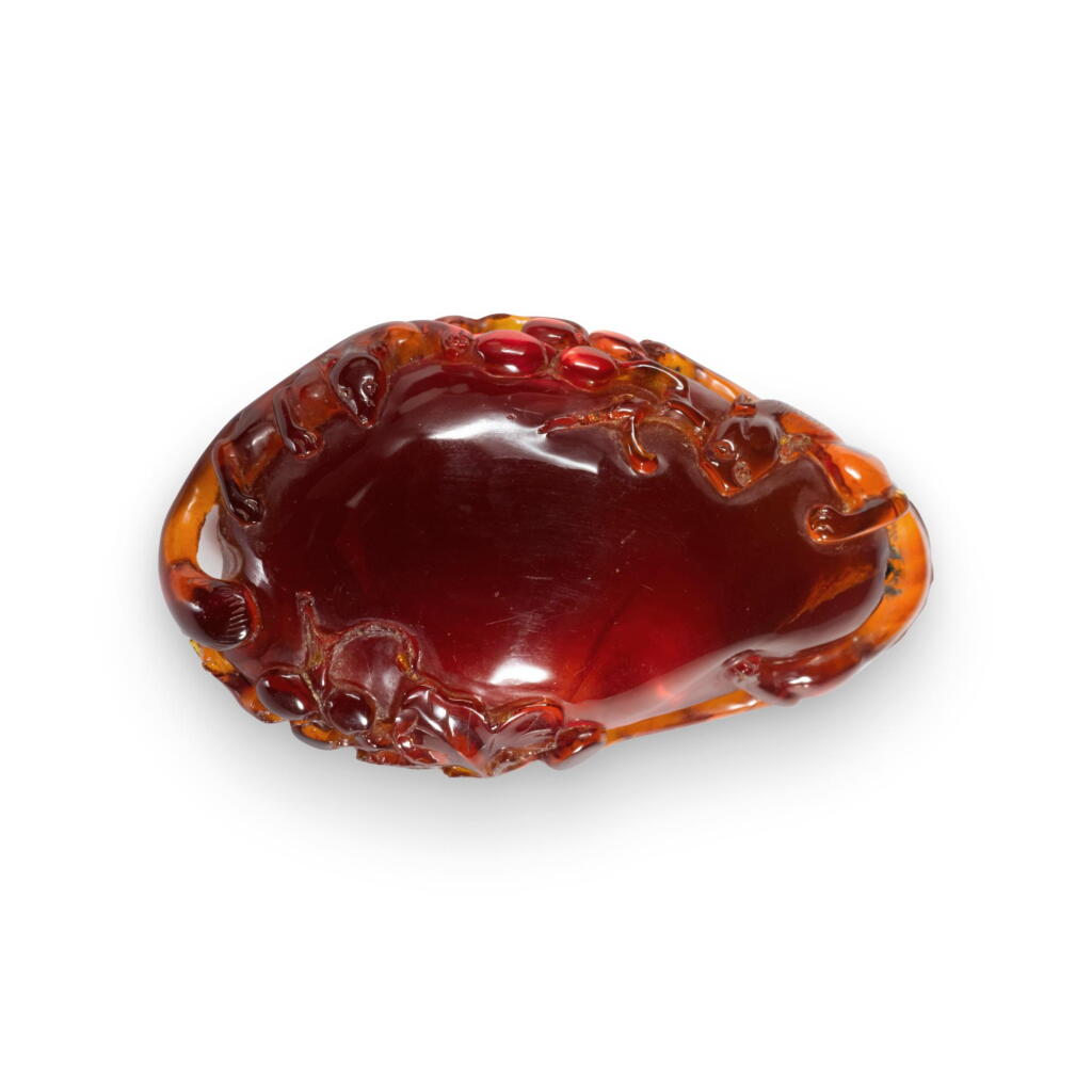 View full screen - View 1 of Lot 798. An amber 'squirrel and grape' pendant, Qing dynasty, 18th century | 清十八世紀 琥珀雕松鼠葡萄紋珮.