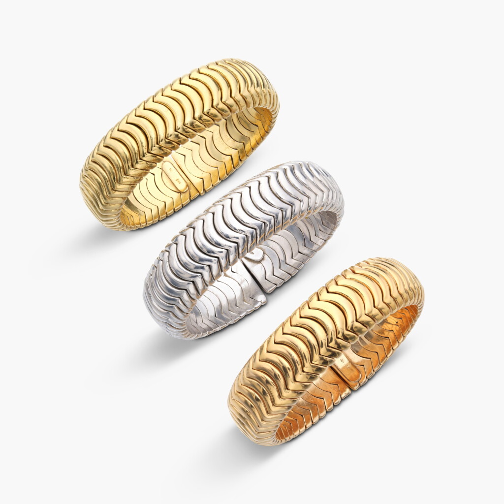 View full screen - View 1 of Lot 931. Three Gold Bangles.