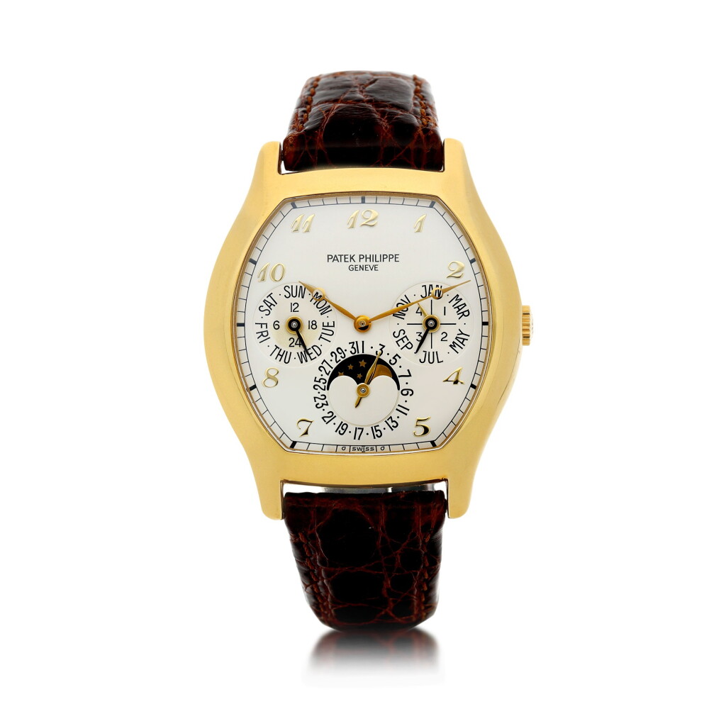View full screen - View 1 of Lot 28. PATEK PHILIPPE | REFERENCE 5040 A YELLOW GOLD TONNEAU-SHAPED AUTOMATIC PERPETUAL CALENDAR WRISTWATCH WITH MOON PHASES, 24-HOUR AND LEAP YEAR INDICATION, MADE IN 1993.