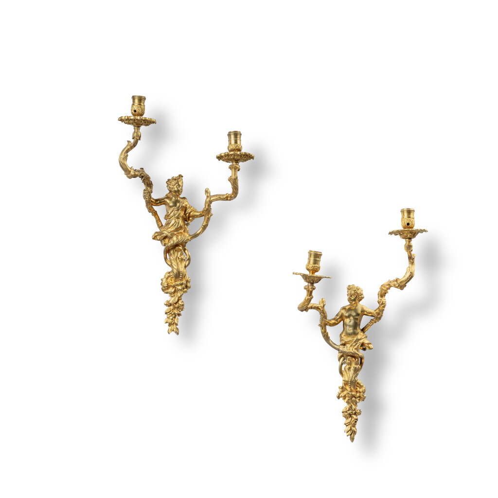 View full screen - View 1 of Lot 202. A pair of French Régence gilt-bronze two-light wall lights, circa 1720, in the style of Gilles-Marie Oppenordt.