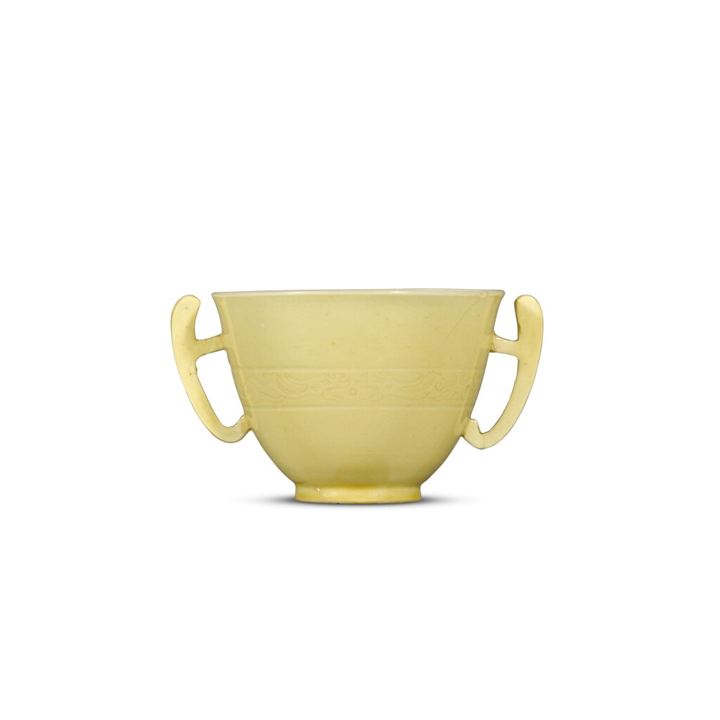 View full screen - View 1 of Lot 11. A yellow-glazed handled cup, Mark and period of Kangxi | 清康熙 黃釉暗刻龍紋耳盃 《大清康熙年製》款.