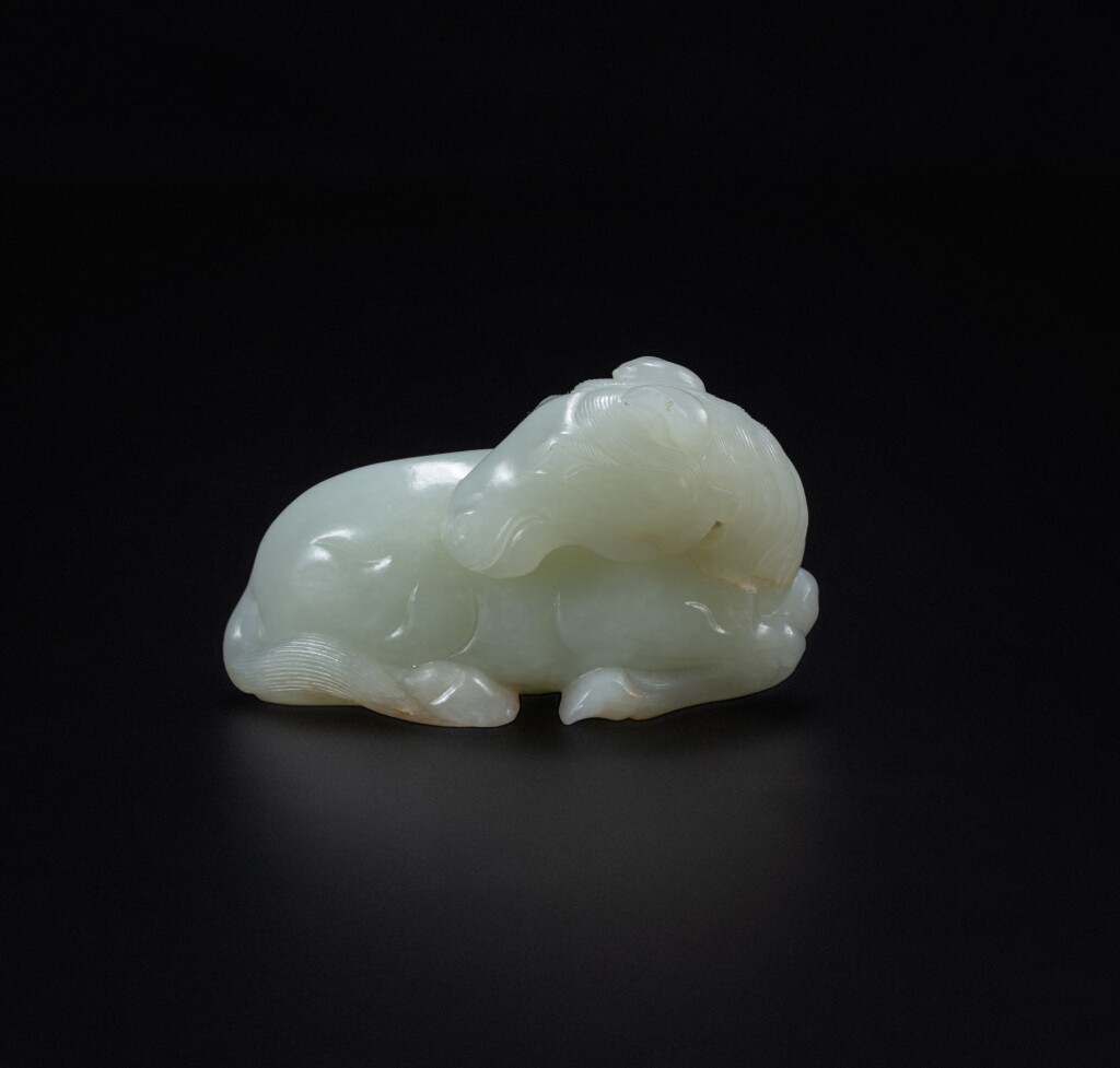View full screen - View 1 of Lot 88. A pale celadon jade 'recumbent horse' carving, Qing dynasty, 18th-19th century | 清十八至十九世紀 青玉雕臥馬擺件.