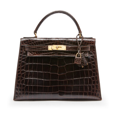 View full screen - View 1 of Lot 88. Chocolate Shiny Caiman Crocodile Sellier Kelly 28 Gold Hardware, 1979.