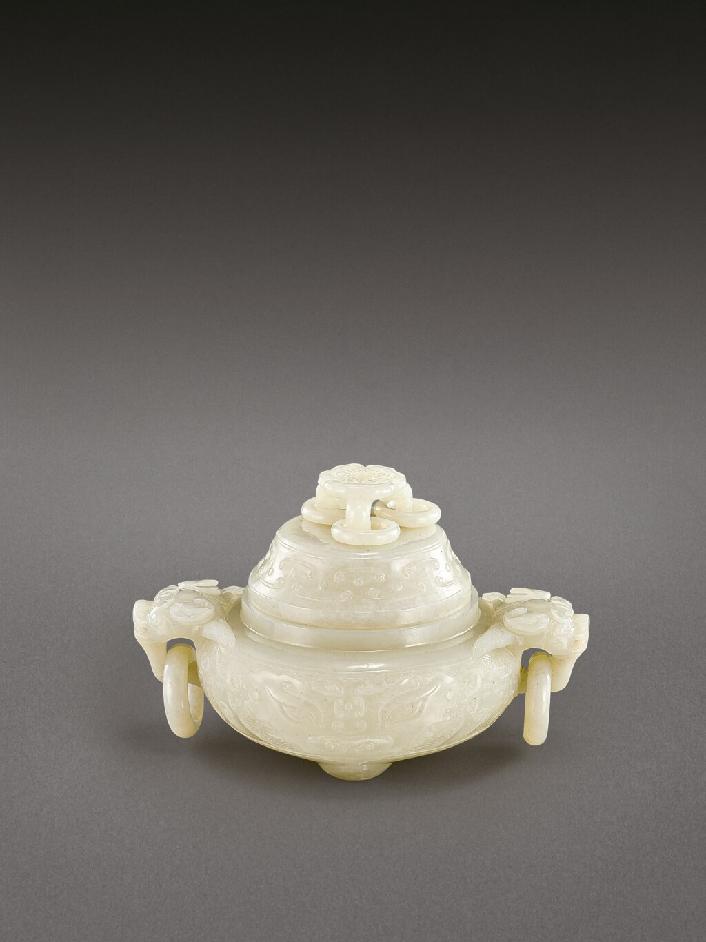 View full screen - View 1 of Lot 2042. A white jade archaistic 'taotie' incense burner and cover Qing dynasty, 18th century | 清十八世紀 白玉仿古饕餮紋雙龍銜環蓋爐.