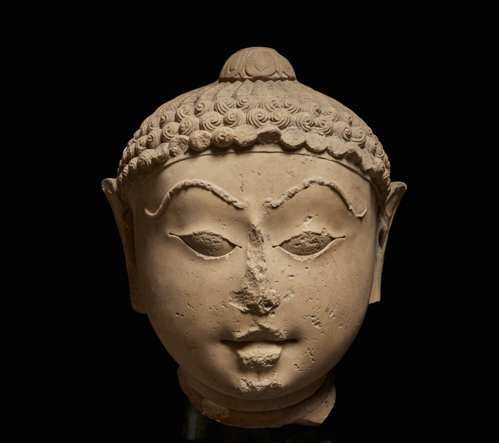View full screen - View 1 of Lot 371. A polished sandstone head of a Jina, Western India, 12th/13th Century.