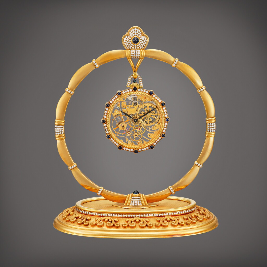 View full screen - View 1 of Lot 2213. Reference 916 An important yellow gold, diamond and sapphire-set skeletonised open face keyless dress watch with matching stand, Made in 1980 | 百達翡麗 | 型號916 重要黃金鑲鑽石及藍寶石鏤空懷錶,備展示座,1980製.