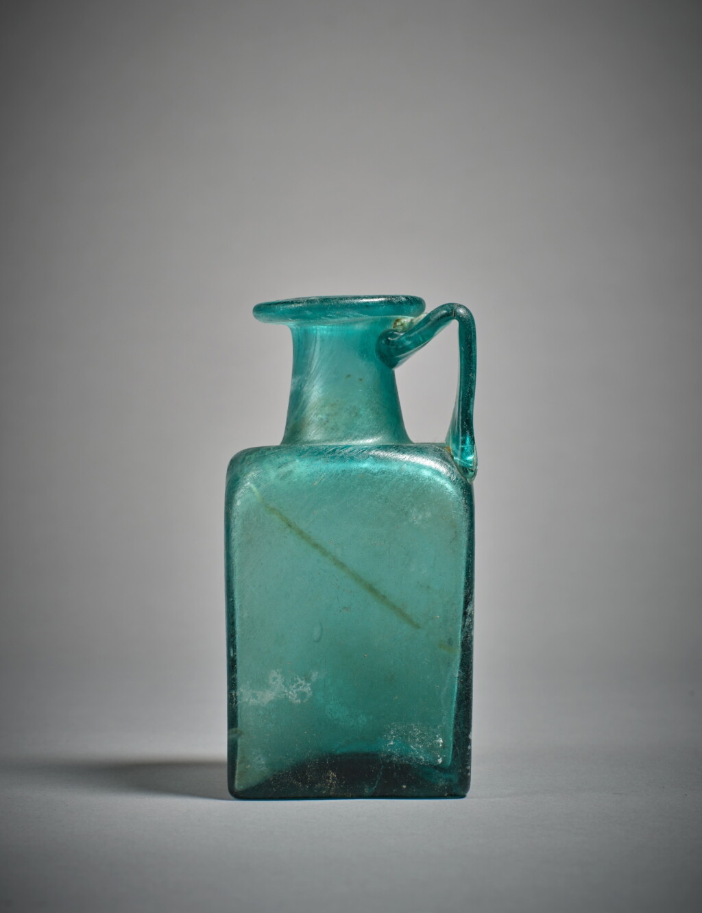 View full screen - View 1 of Lot 602. A Gallo-Roman Green Glass Jug, circa 2nd Century A.D..
