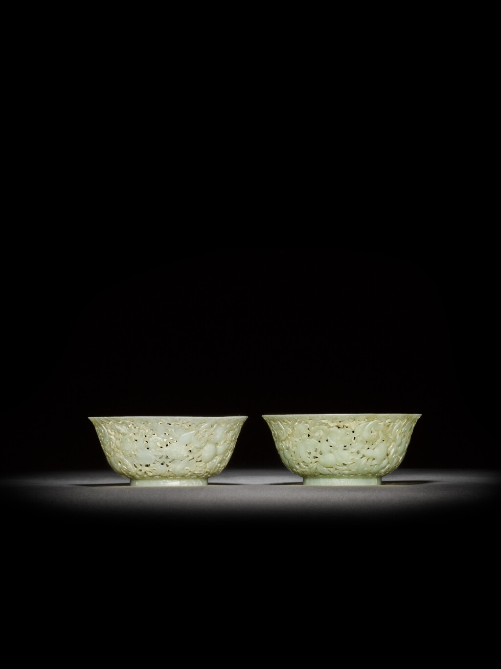 View full screen - View 1 of Lot 18. A pair of reticulated pale celadon jade 'gourd' bowls, Qing dynasty, 18th century | 清十八世紀 青白玉鏤雕葫蘆紋盌一對.