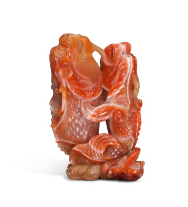 View full screen - View 1 of Lot 240. A carnelian agate 'double carp' vase, Qing Dynasty, 18th/19th century | 清十八/十九世紀 南紅瑪瑙雙魚花插.