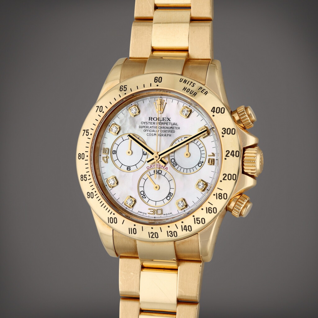 View full screen - View 1 of Lot 14. Reference 116528H Daytona | A yellow gold and diamond-set automatic chronograph wristwatch with bracelet and mother-of-pearl dial, Circa 2007.