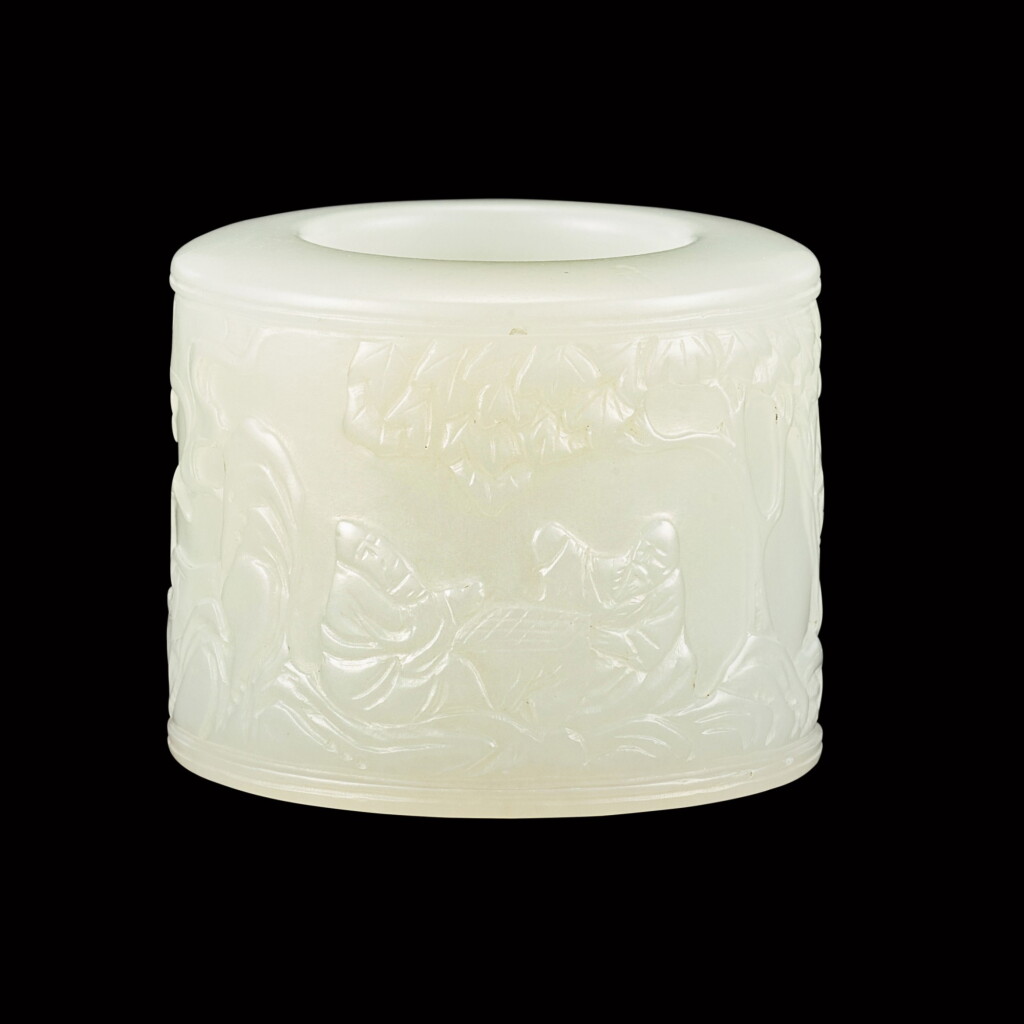 View full screen - View 1 of Lot 153. An inscribed white jade 'chess playing' thumb ring Qing dynasty | 清 白玉秋山對弈圖扳指.