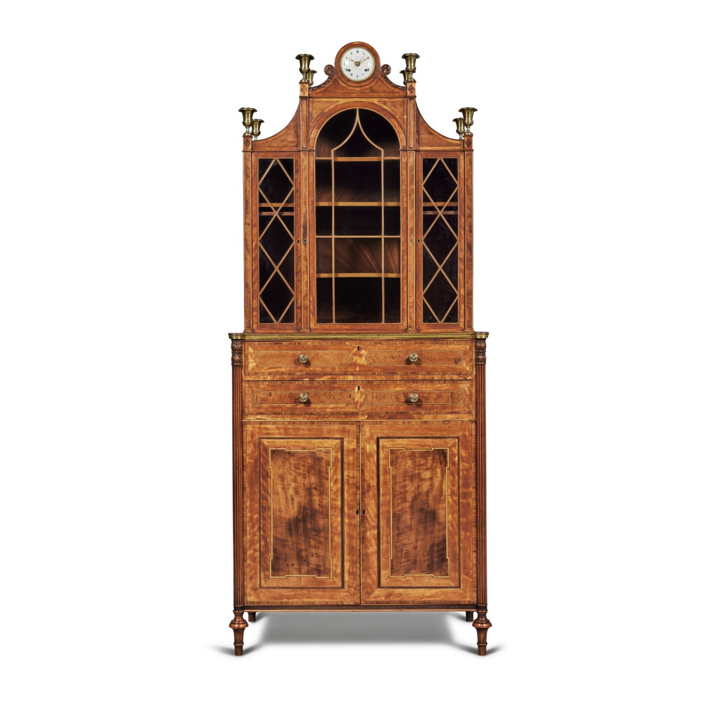View full screen - View 1 of Lot 59. A George III Lacquered Brass-Mounted Satinwood, Sabicu and Tulipwood Cross-Banded Secretaire Bookcase attributed to George Simson and retailed by Thomas Weeks, Circa 1800.