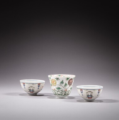 View full screen - View 1 of Lot 127. A pair of wucai cups and a famille-verte 'lotus' cup, Qing dynasty, 18th century .