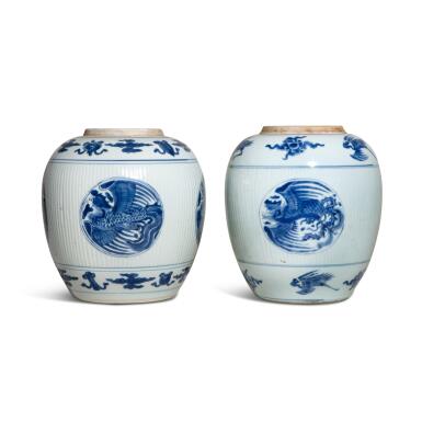 View full screen - View 1 of Lot 933. Two blue and white ribbed 'phoenix' ovoid jars, Qing dynasty, Kangxi period | 清康熙 青花開光團鳳紋罐一組兩件.