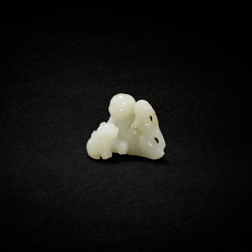 View full screen - View 1 of Lot 718. A pale celadon jade 'luohan and lion' group, Qing dynasty, 19th century | 清十九世紀 白玉笑獅羅漢擺件.