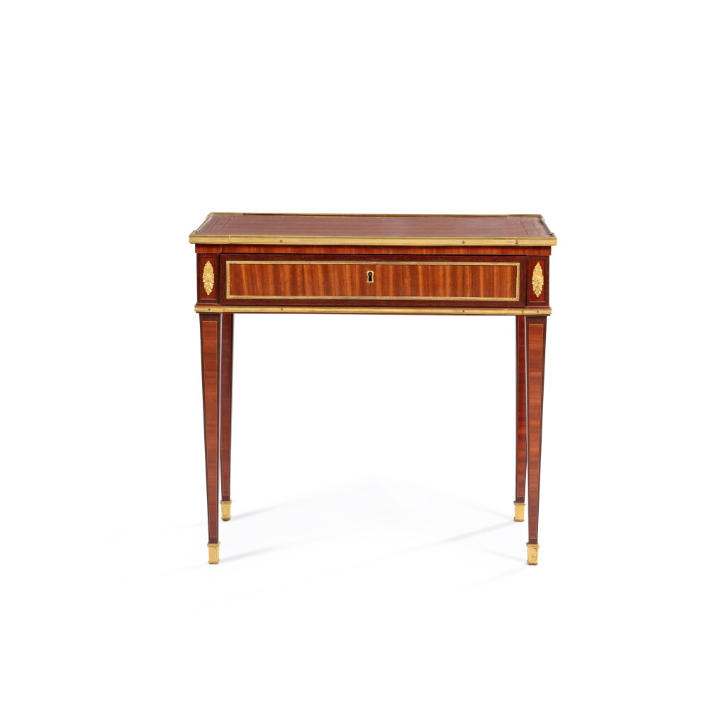 View full screen - View 1 of Lot 243. A Louis XVI gilt-bronze mounted amaranth, satinwood, holly veneered writing table, stamped by Conrad Mauter circa 1785.