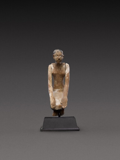 View full screen - View 1 of Lot 134. An Egyptian Polychrome Wood Figure of a Boatman, 11th/early 12th dynasty, circa 2081-1850 B.C..