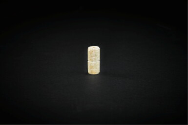 View full screen - View 1 of Lot 3786. A calcified jade 'animal mask' bead, Neolithic period, Liangzhu culture, 3rd millennium BC | 新石器時代 良渚文化 公元前三千年 獸面紋玉管飾.