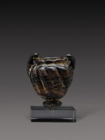 A Late Roman Black and Red Core-Formed Glass Cosmetic Jar, circa 5th/7th century A.D.