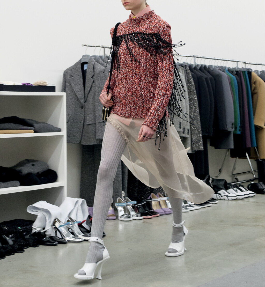 View full screen - View 1 of Lot 26. PRADA | BEADED FRINGE WOOL SWEATER, POPLIN SHIRT, SILK ORGANZA SKIRT, POPLIN TIE .