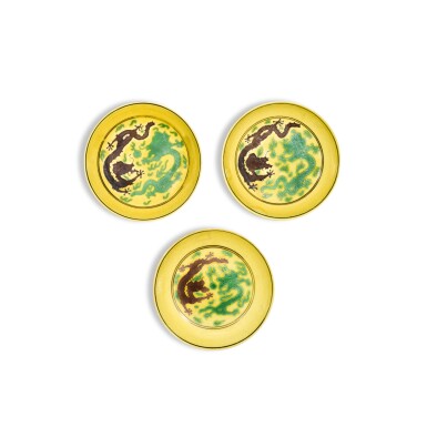 View full screen - View 1 of Lot 310. Three yellow-ground green-and-aubergine-enamelled 'dragon' dishes, Marks and period of Guangxu.