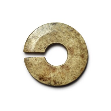 View full screen - View 1 of Lot 225. A calcified jade slit disc (Jue), Neolithic period / Shang dynasty | 新石器時代 / 商 玉玦.