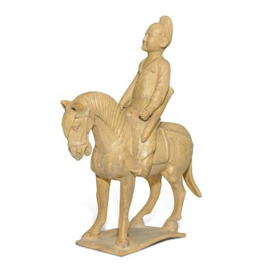 View full screen - View 1 of Lot 700. A straw-glazed pottery figure of a horse and equestrian, Tang dynasty | 唐 白釉騎馬俑.
