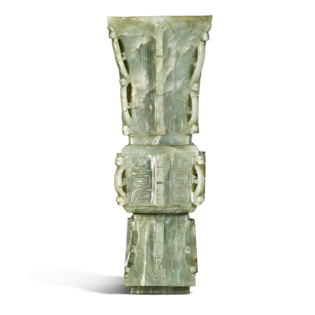 View full screen - View 1 of Lot 938. AN ARCHAISTIC CELADON JADE GU-FORM VASE WITH OPENWORK CORNER FLANGES, LATE QING DYNASTY.