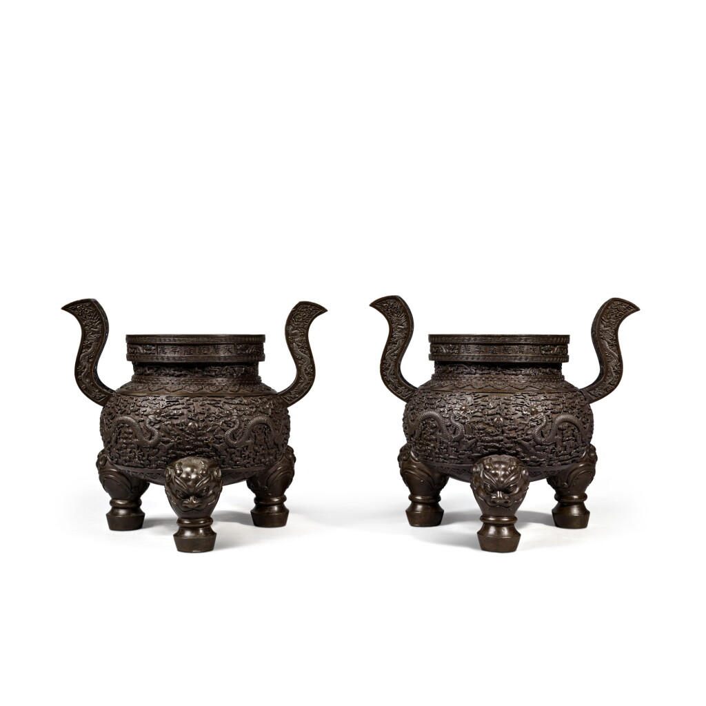 View full screen - View 1 of Lot 15. A rare pair of bronze 'dragon' tripod censers, Marks and period of Qianlong | 清乾隆 銅雲龍戲珠紋朝冠耳三足爐一對.