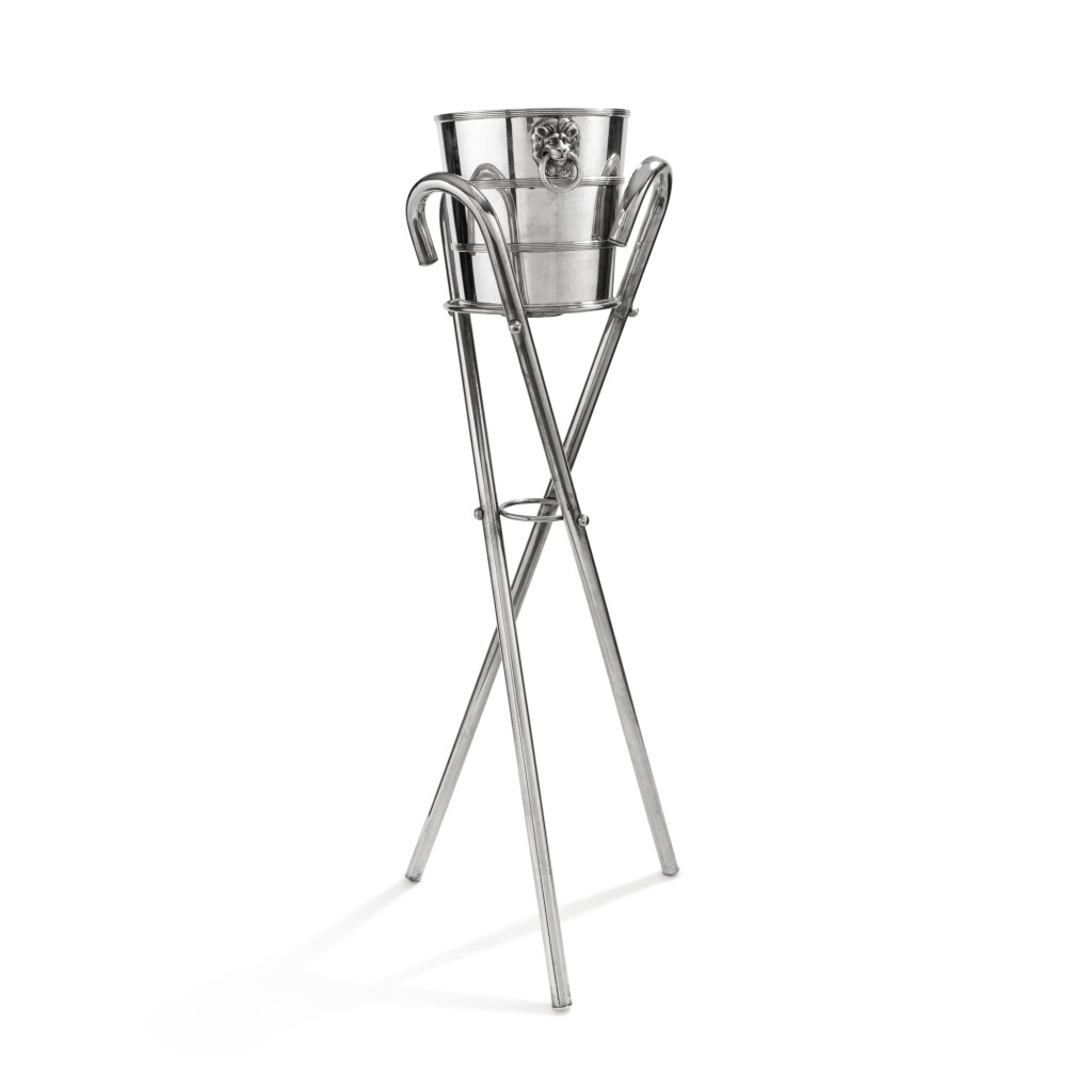 View full screen - View 1 of Lot 361. An Italian silver bottle-bucket, Buccellati, Milan, circa 1980 and a stand made of 3 silver metal canes | Seau à bouteille en argent par Buccellati, Milan, vers 1980 et un support formé de 3 cannes en métal-argenté.