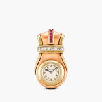 New York retailed | Clip de Revers | A yellow and pink gold, diamond and ruby-set lyre-form clip watch, Circa 1937