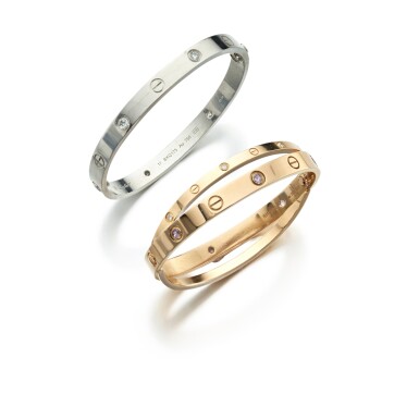View full screen - View 1 of Lot 711. Two Gold and Gemset and Diamond 'Love' Bangles.