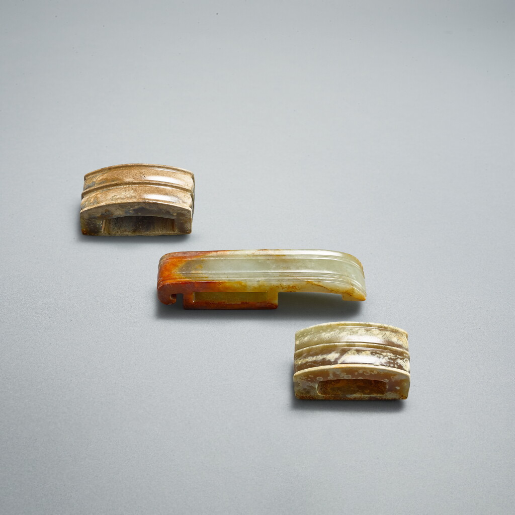 View full screen - View 1 of Lot 754. A group of three jade scabbard slides, Western Han dynasty | 西漢 瓦溝紋玉劍璏一組三件 .