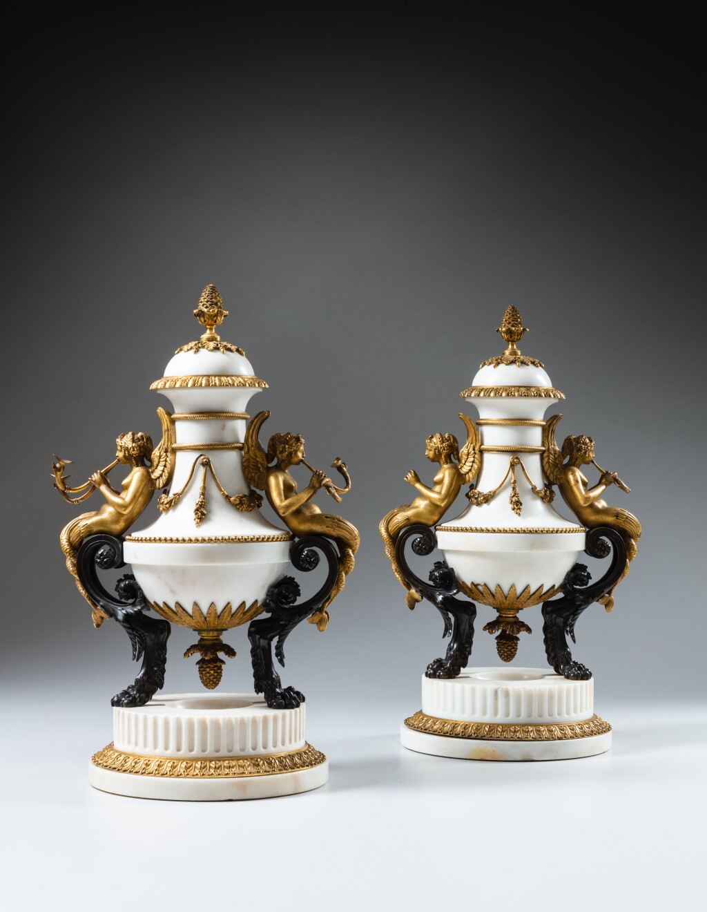 View full screen - View 1 of Lot 158. A pair of Louis XVI gilt-bronze mounted marble cassolettes, circa 1785-1790, attributed to Pierre-Philippe Thomire | Paire de cassolettes en bronze patiné, doré et marbre blanc d'époque Louis XVI vers 1785-1790, attribuées à Pierre-Philippe Thomire.