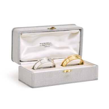 View full screen - View 1 of Lot 24. Hermès: a cased pair of silver and silver-gilt napkin rings, Hermès, Paris circa 1950.