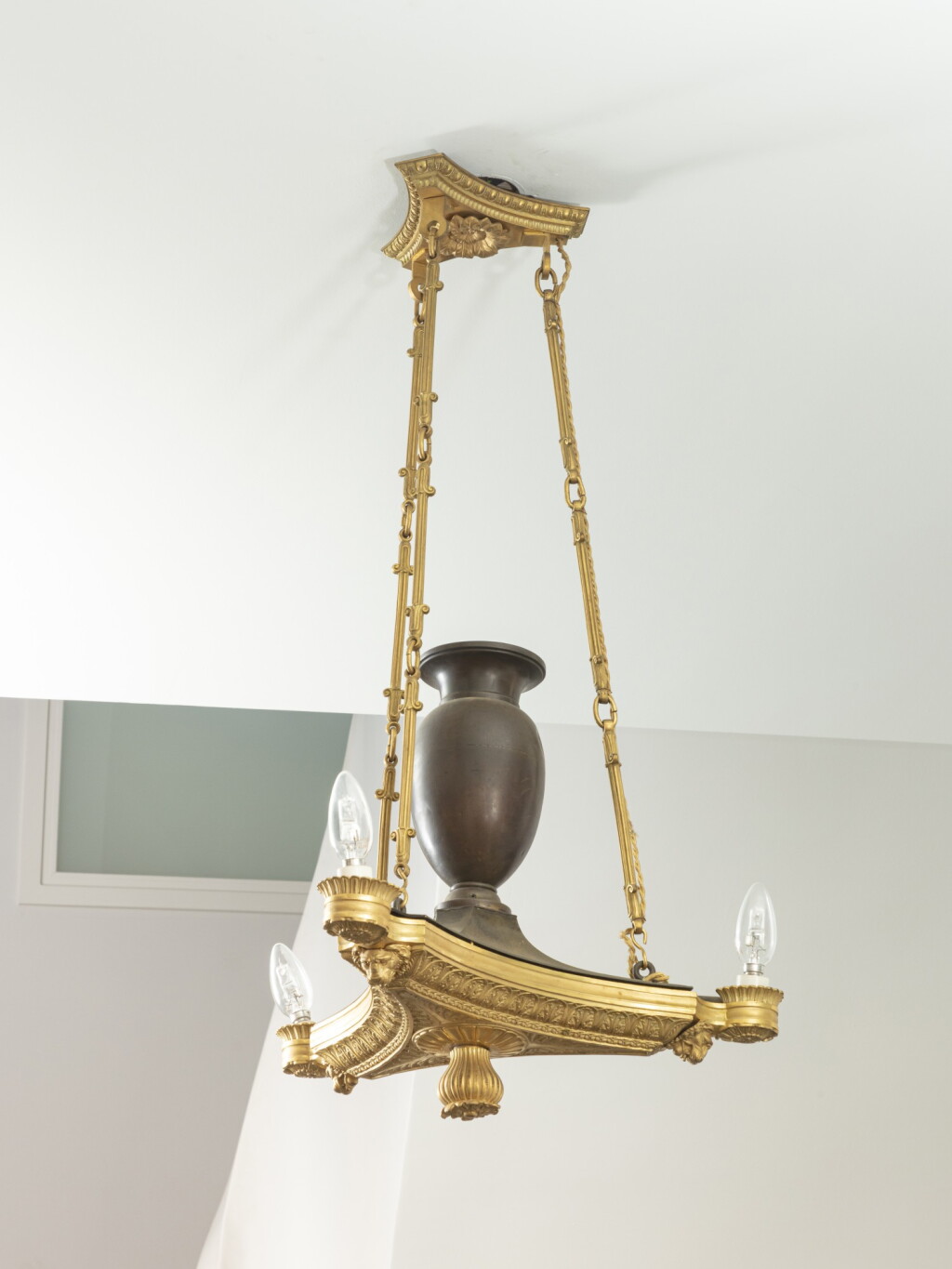 View full screen - View 1 of Lot 212. A gilt patinated bronze three-light oil chandelier, Regency, circa 1830.