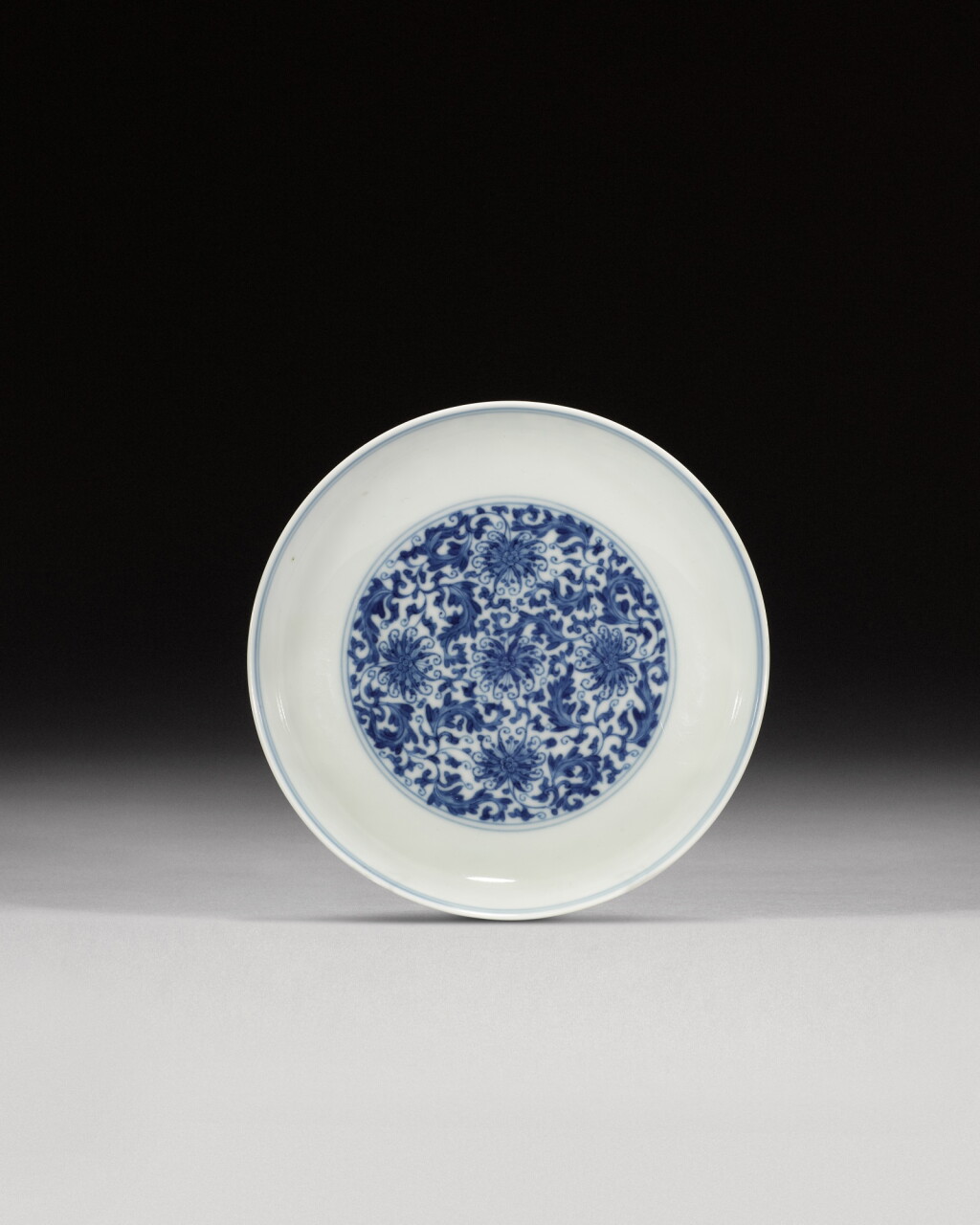 View full screen - View 1 of Lot 153. A small blue and white 'lotus' dish, Mark and period of Yongzheng | 清雍正 青花纏枝花卉圖盤《大清雍正年製》款.
