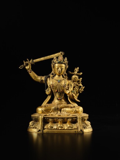 View full screen - View 1 of Lot 104. A gilt-copper alloy figure of Manjushri, Qing dynasty, 18th century.