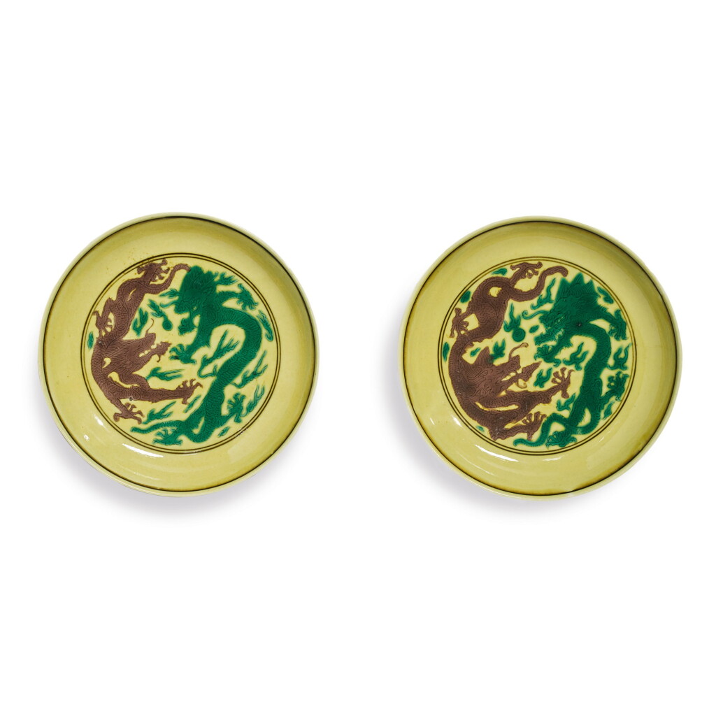 View full screen - View 1 of Lot 559. A PAIR OF GREEN AND AUBERGINE-ENAMELED YELLOW-GROUND 'DRAGON' DISHES, KANGXI MARKS AND PERIOD.