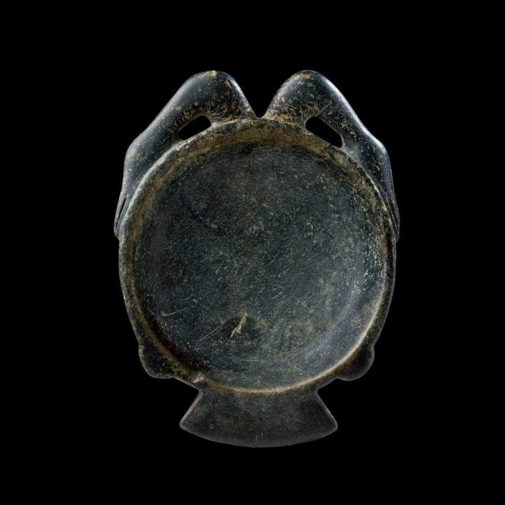 View full screen - View 1 of Lot 56. An Egyptian Steatite Offering Spoon, New Kingdom, 1550-1075 B.C. .