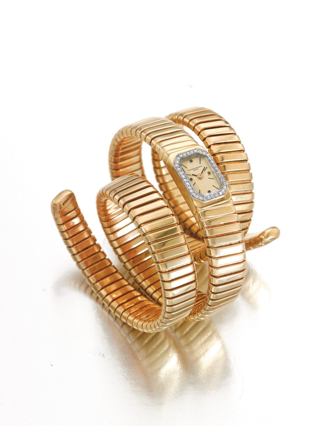 View full screen - View 1 of Lot 126. VACHERON CONSTANTIN | RETAILED BY BULGARI: A YELLOW GOLD AND DIAMOND SET TUBOGAS CUFF WATCH CIRCA 1970.