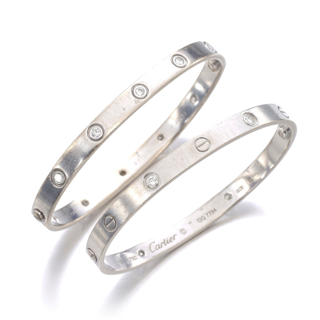 View full screen - View 1 of Lot 8. CARTIER | TWO GOLD AND DIAMOND BANGLES, 'LOVE'.